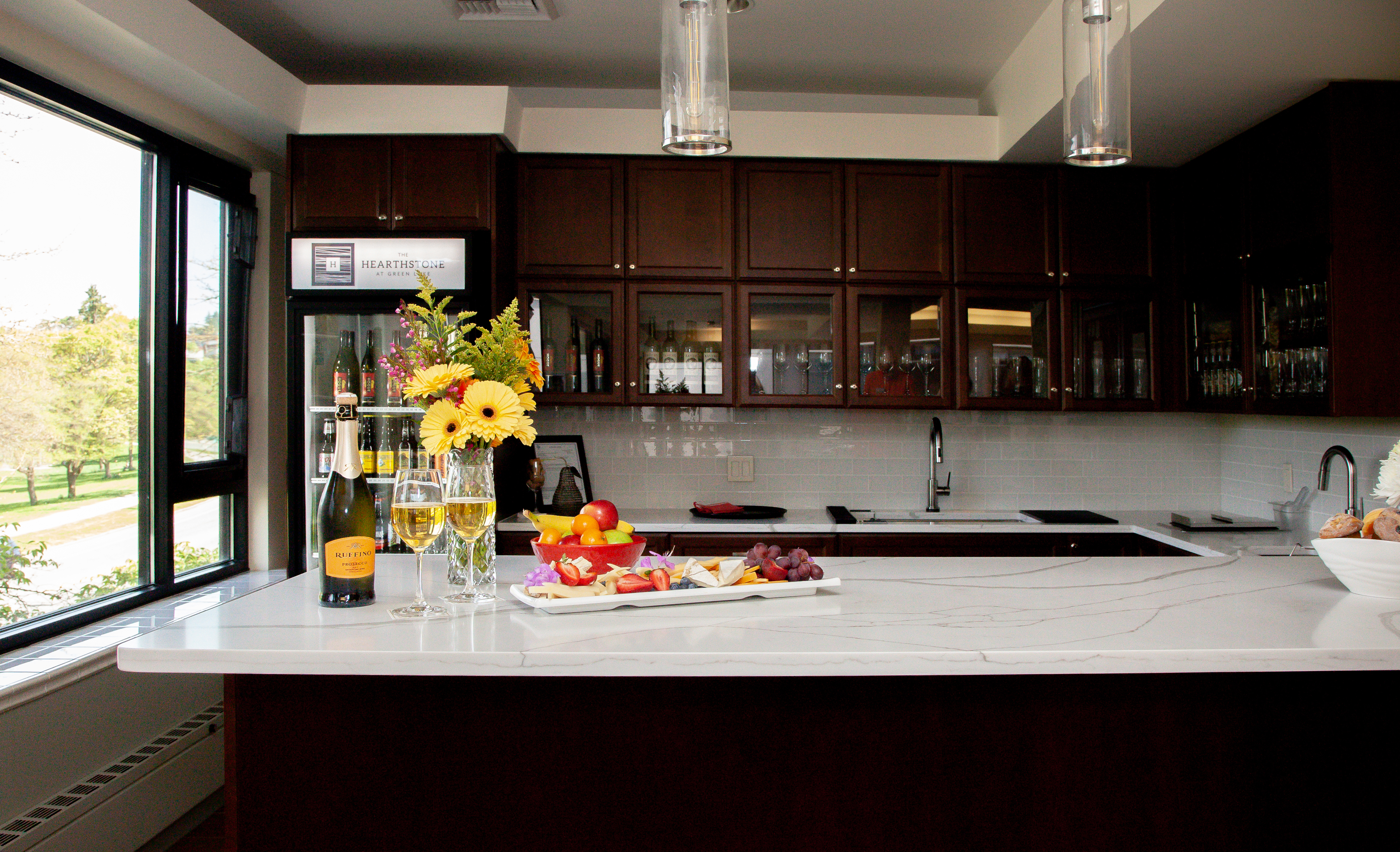 Water's Edge kitchen with an assortment of flowers, wine and treats on the countertop.